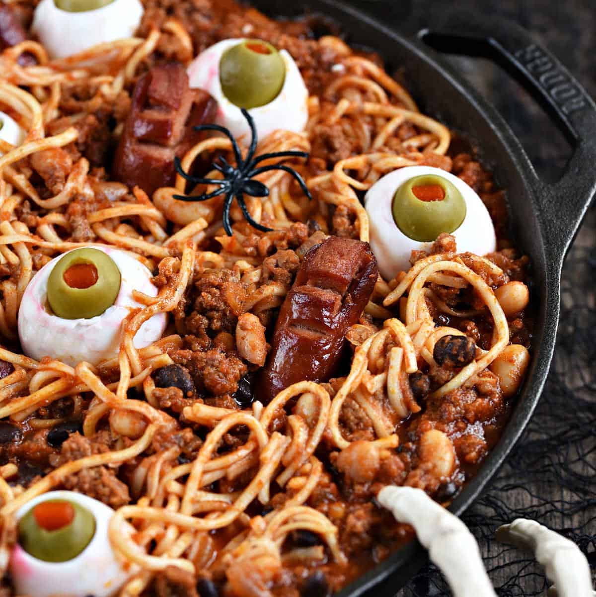 Spooky Halloween Chili with noodles, beans, egg eyes, and hot dog fingers and toes.