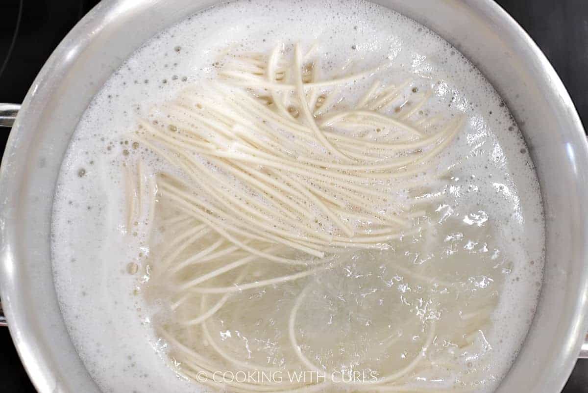 Udon noodles in boiling water. 
