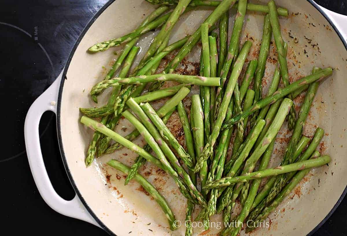 Asparagus spears in a skillet. 