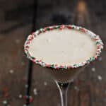 Christmas Cookie Martini in a glass rimmed with holiday sprinkles.