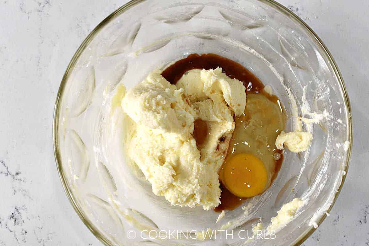 Creamed butter and sugar with vanilla extract and an egg in a large bowl. 