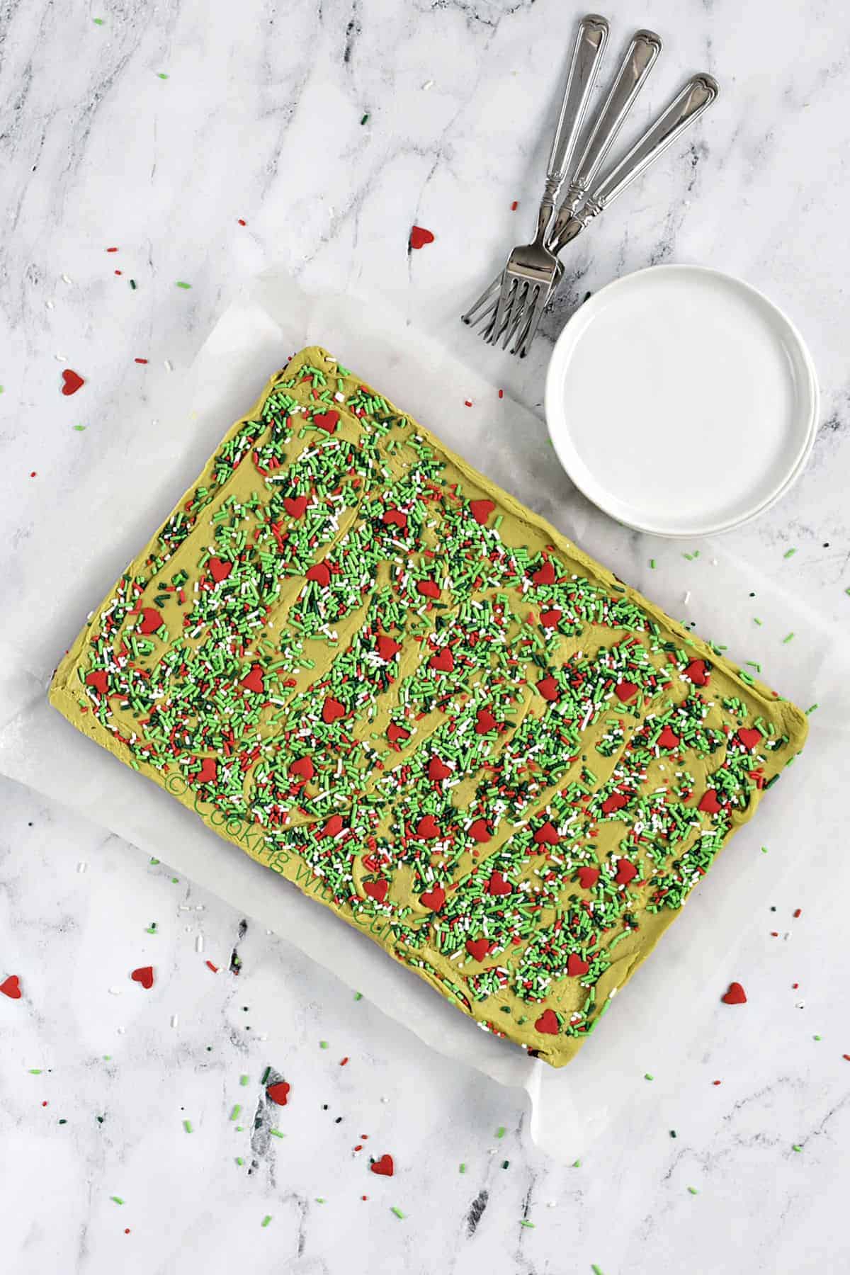 A full pan of Grinch Fudge topped Brownies with holiday sprinkles.