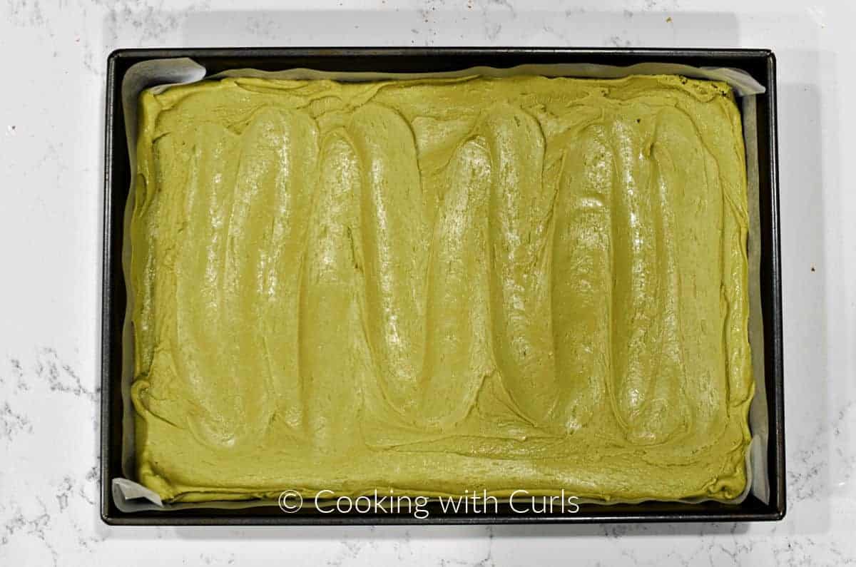 Green fudge spread over the brownies. 