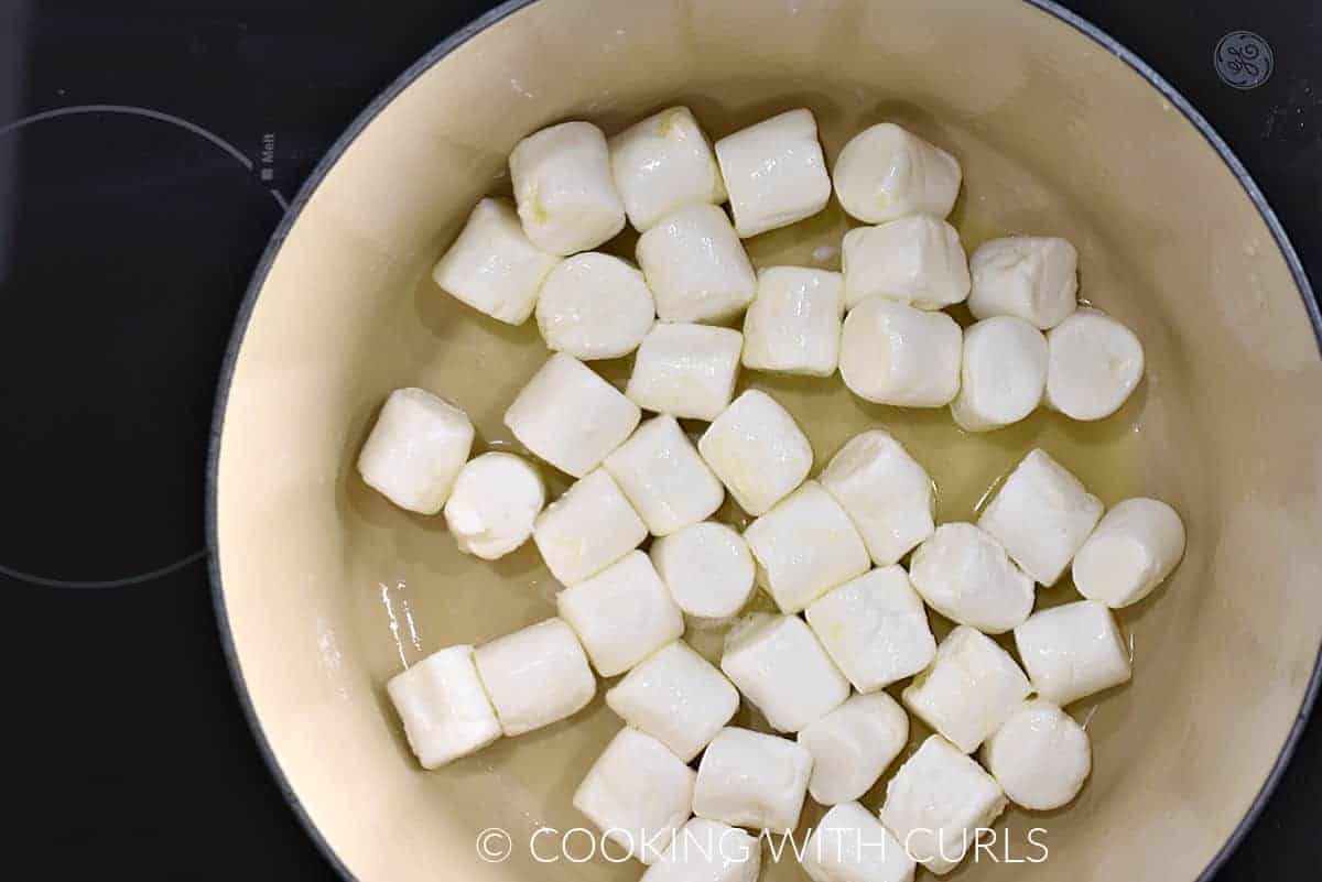 Large marshmallows tossed with melted butter in a large pot. 