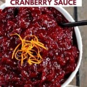 Amaretto cranberry sauce in a bowl topped with orange zest and title graphic across the top.