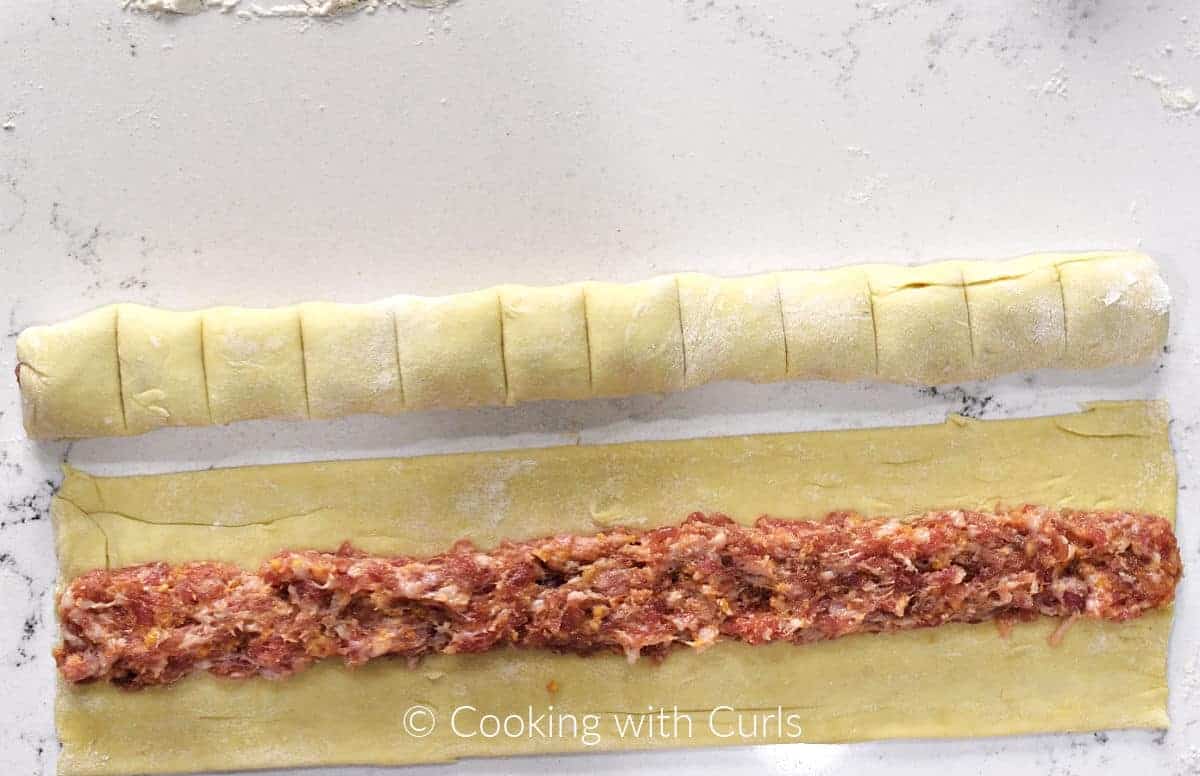 Score lines on the top of the rolled puff pastry sausage bites. 