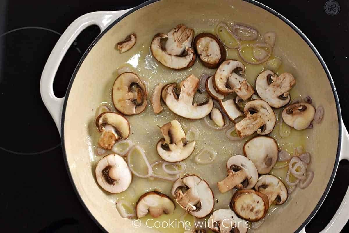 Sliced mushrooms, shallots and melted butter in a skillet. 