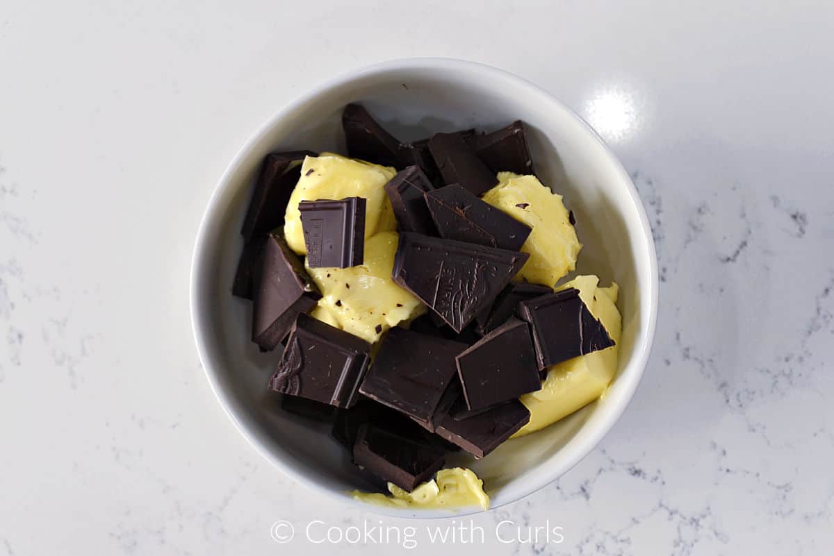 Unsweetened chocolate and butter in a small bowl. 