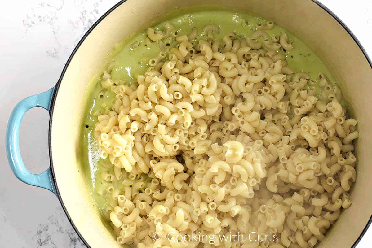 Cooked elbow macaroni added to the green cheese sauce. 