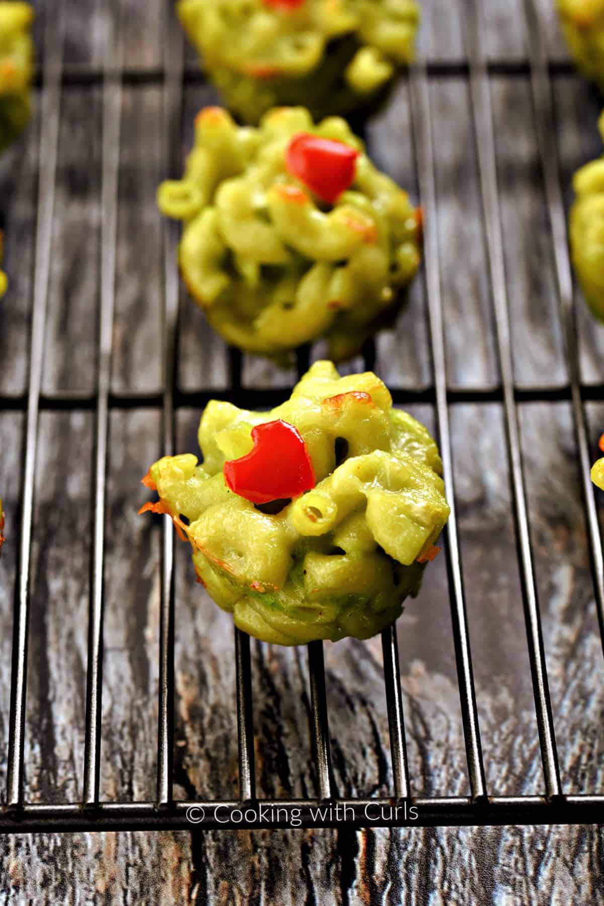 Grinch Mac and Cheese Bites on a wire cooling rack.