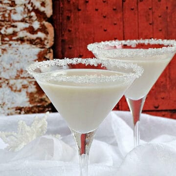 Two snowflake martinis in sugar crystal rimmed martini glasses.