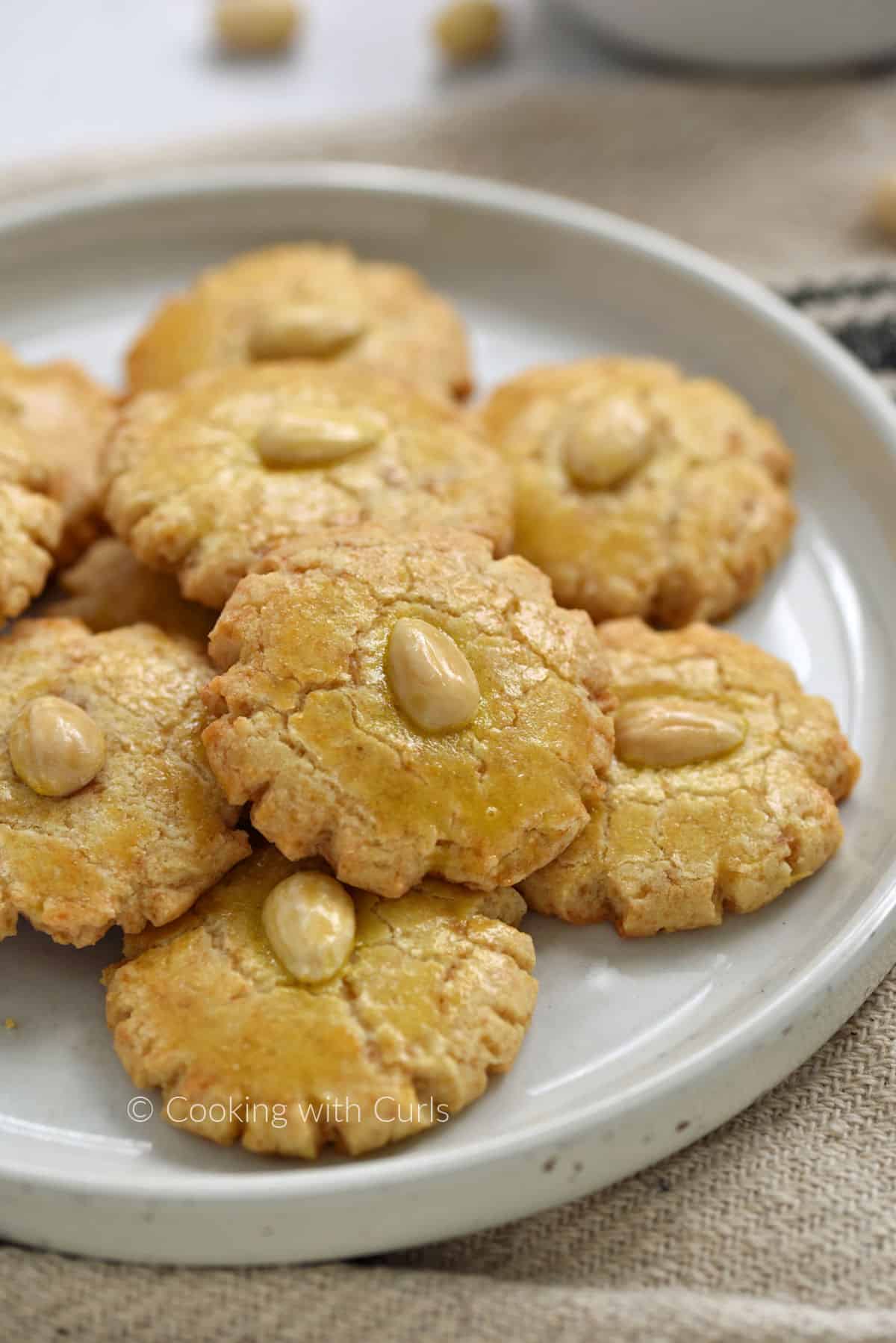 Ten Chinese Almond Cookies stacked on a white plate.