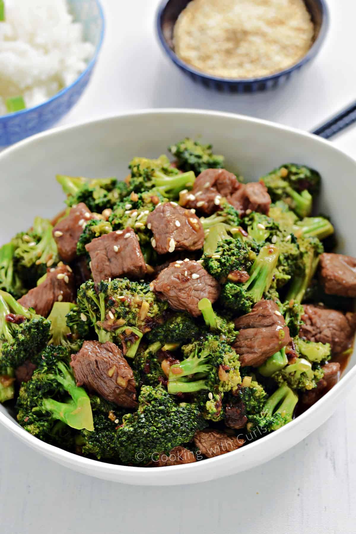 Beef and Broccoli with toasted sesame seeds in a large serving bowl.