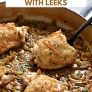 Coq au Riesling chicken thighs with Leeks in a skillet with title graphic across the top.