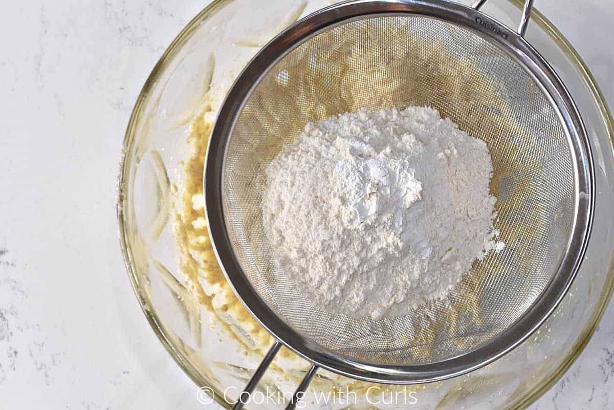 Flour, salt, and baking powder in a sifter over the sugar mixture. 