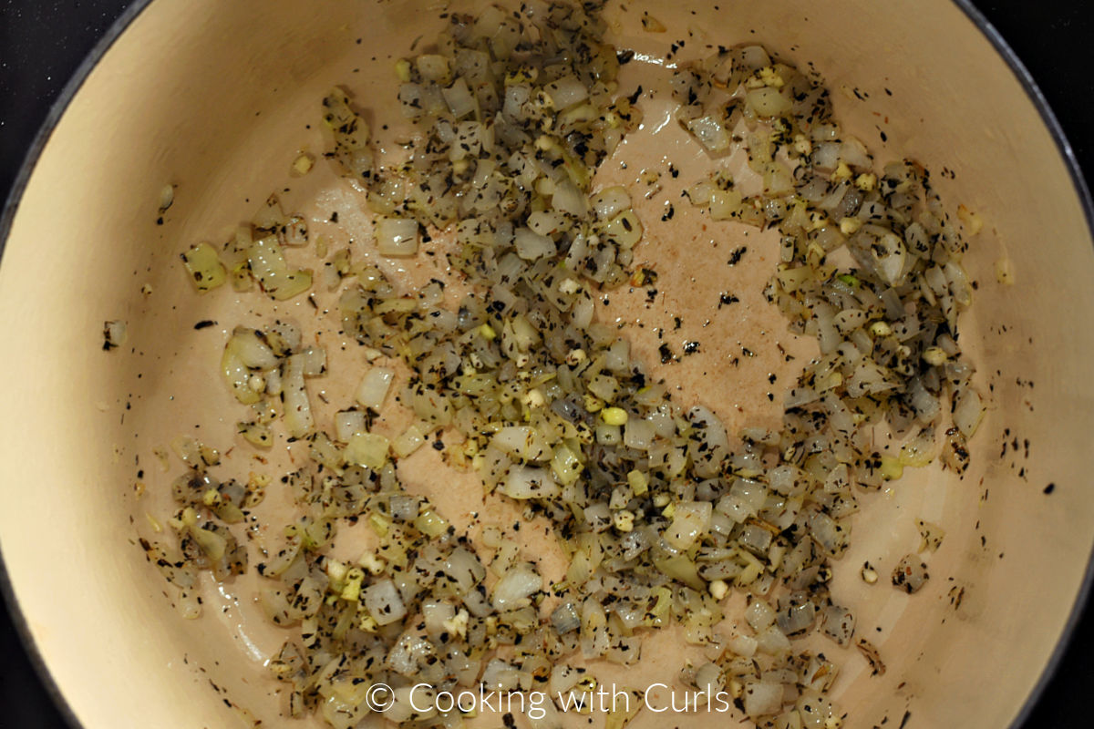 Herbs de Provence and garlic added to the onions in the pot. 