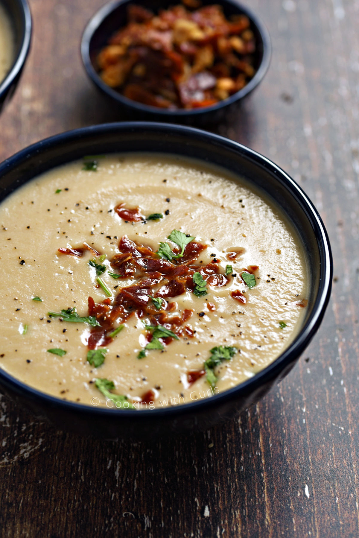Creamy cauliflower soup topped with crumbled, crispy prosciutto and chopped parsley.