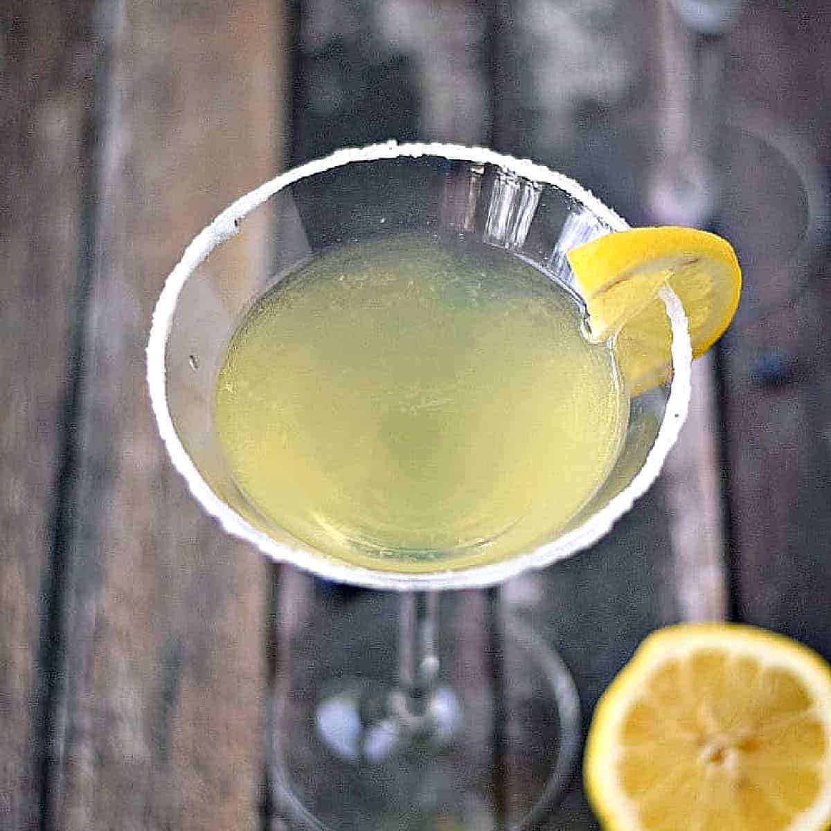 Lemon Drop Martini with a sugar coated rim and lemon wedge garnish.