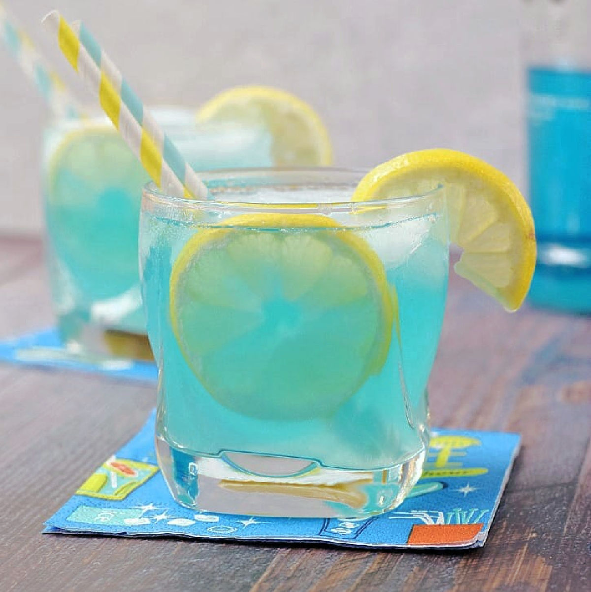Blue Vodka Lemonade Cocktail recipe garnished with a lemon wedge.