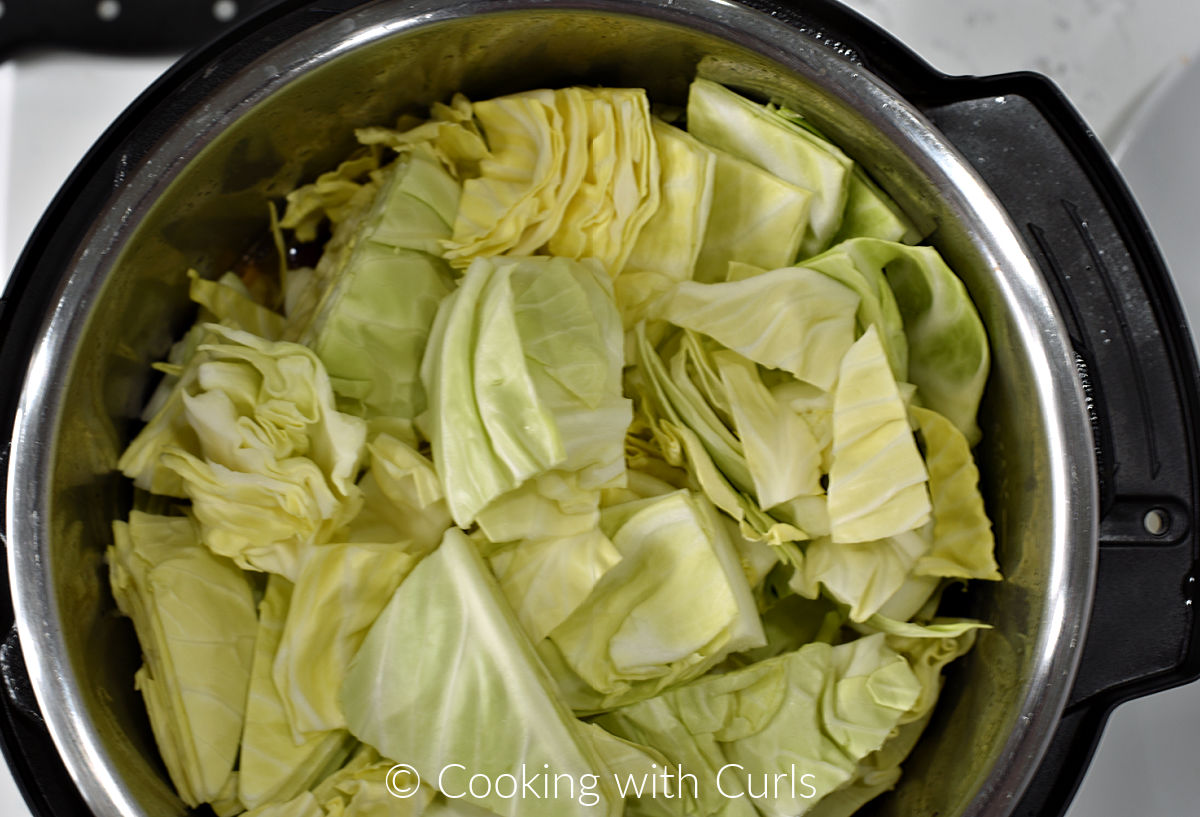 Cabbage wedges added on top of the corned beef in the instant pot. 