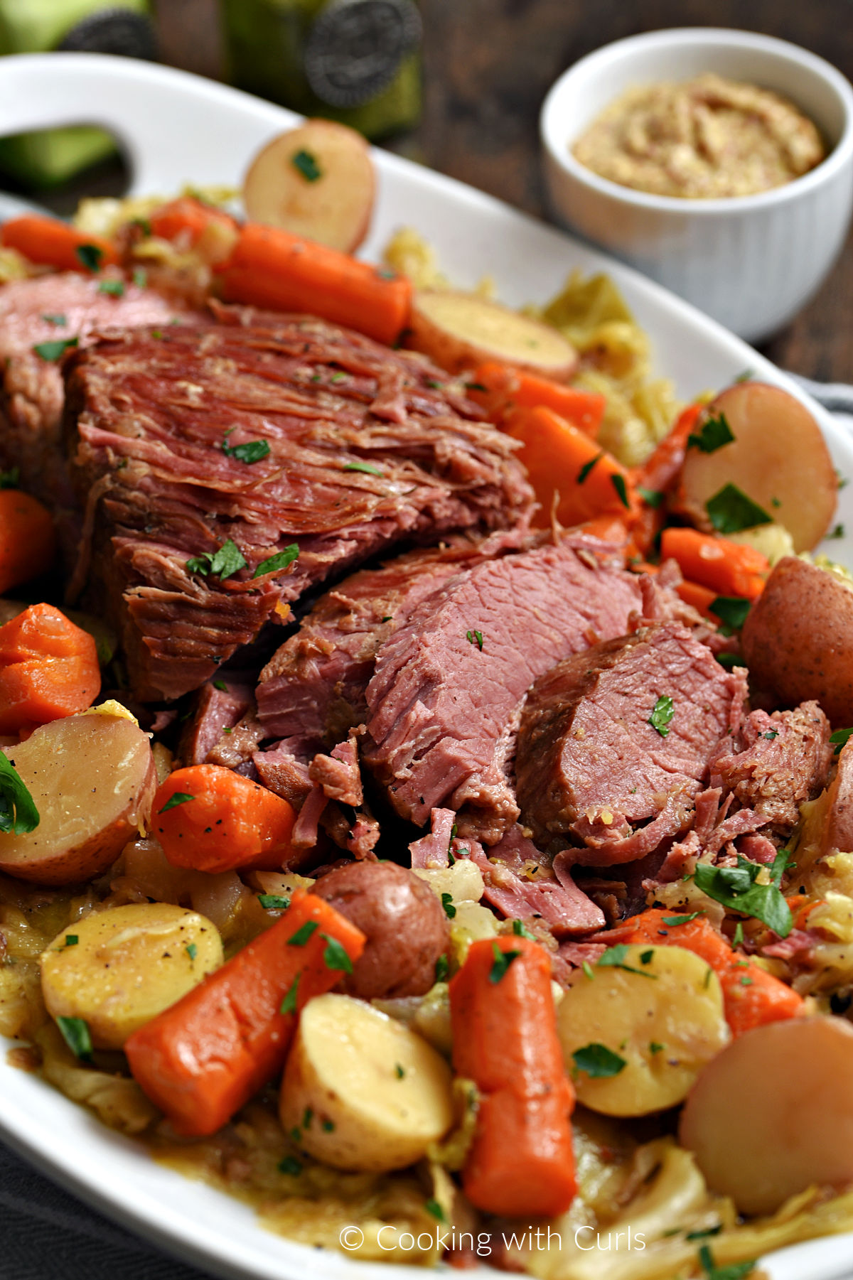 Corned Beef, cabbage, halved potatoes and carrot chunks on a serving platter. 