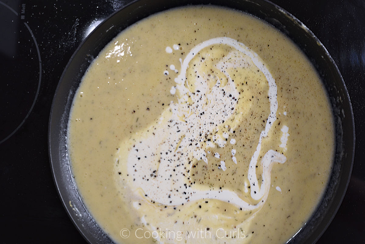 Cream and fish stock added to the roux in a non-stick skillet. 
