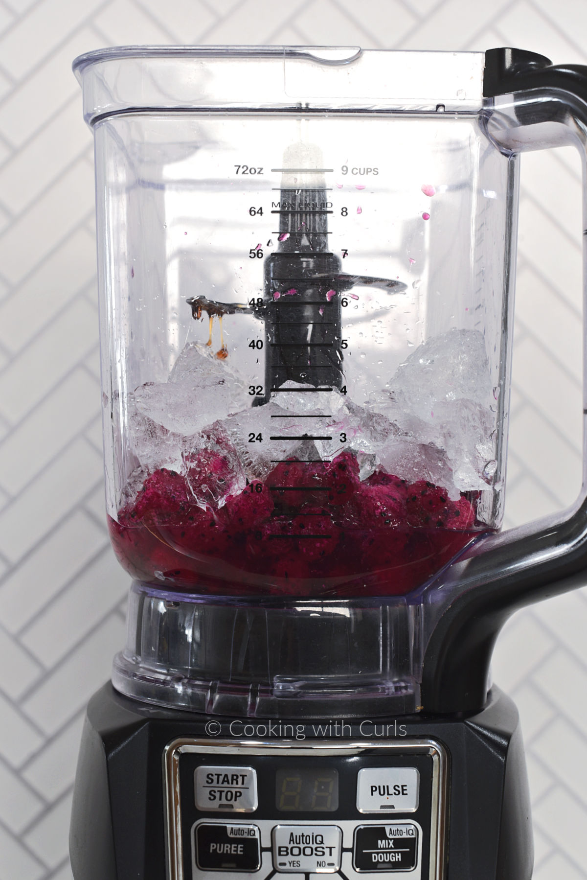 Dragon Fruit, ice cubes, tequila, honey, lime juice, and orange liqueur in a blender. 