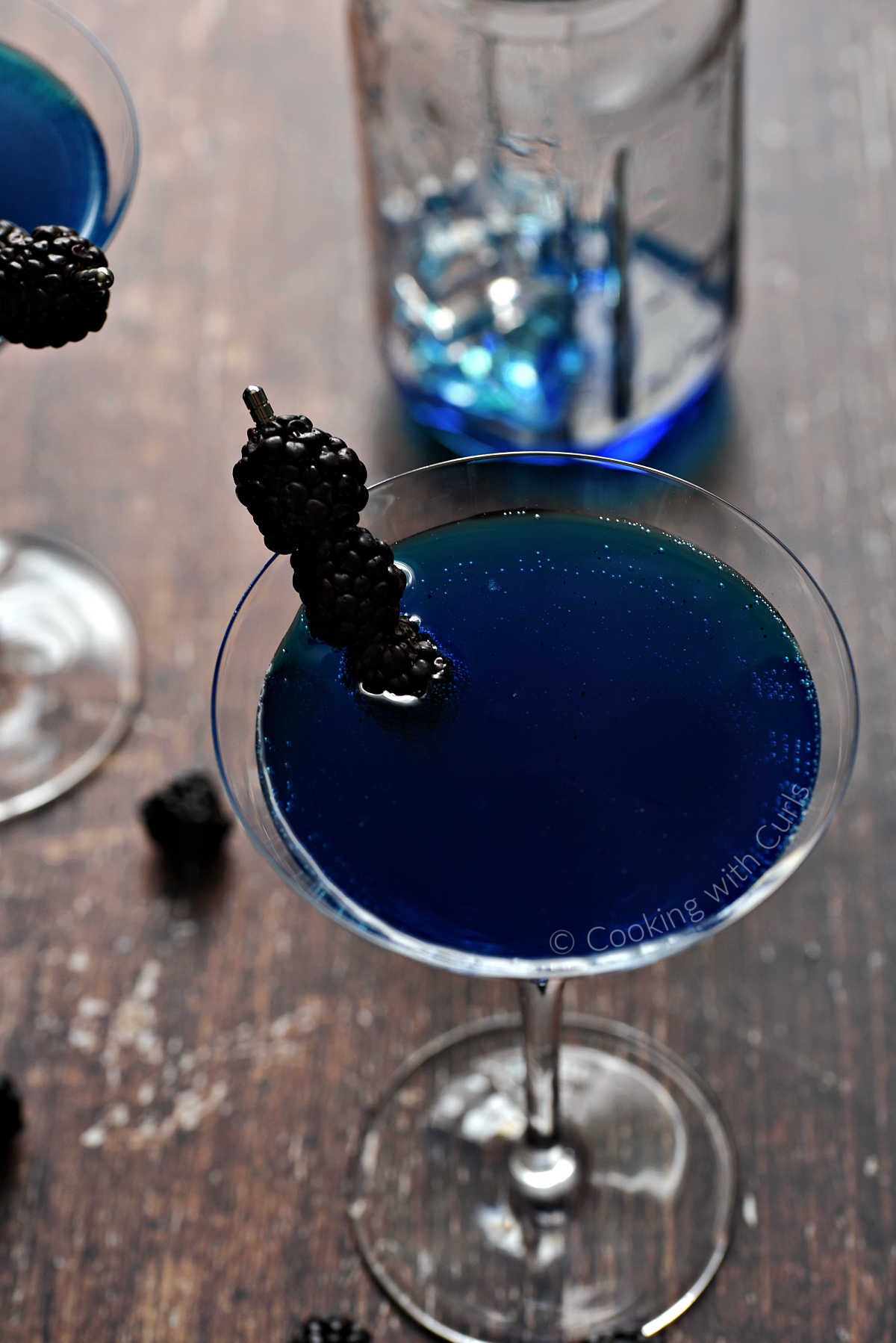 Royal Blue Martini garnished with three blackberries. 