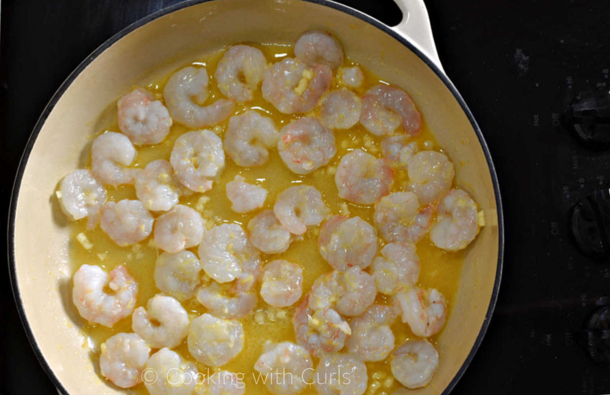 Shrimp, garlic, wine, lemon zest and juice in a large skillet. 