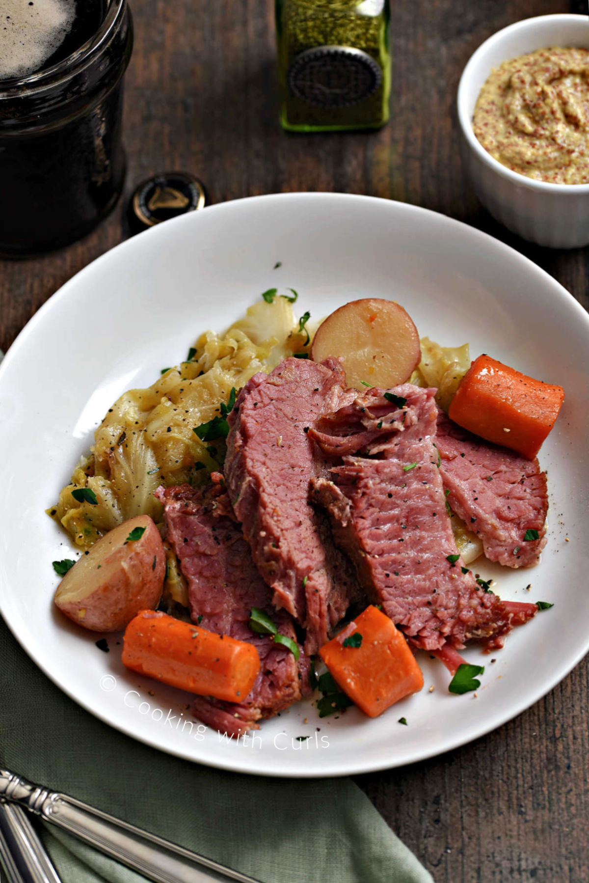 Sliced corned beef, cabbage, red potatoes and carrots in a bowl. 