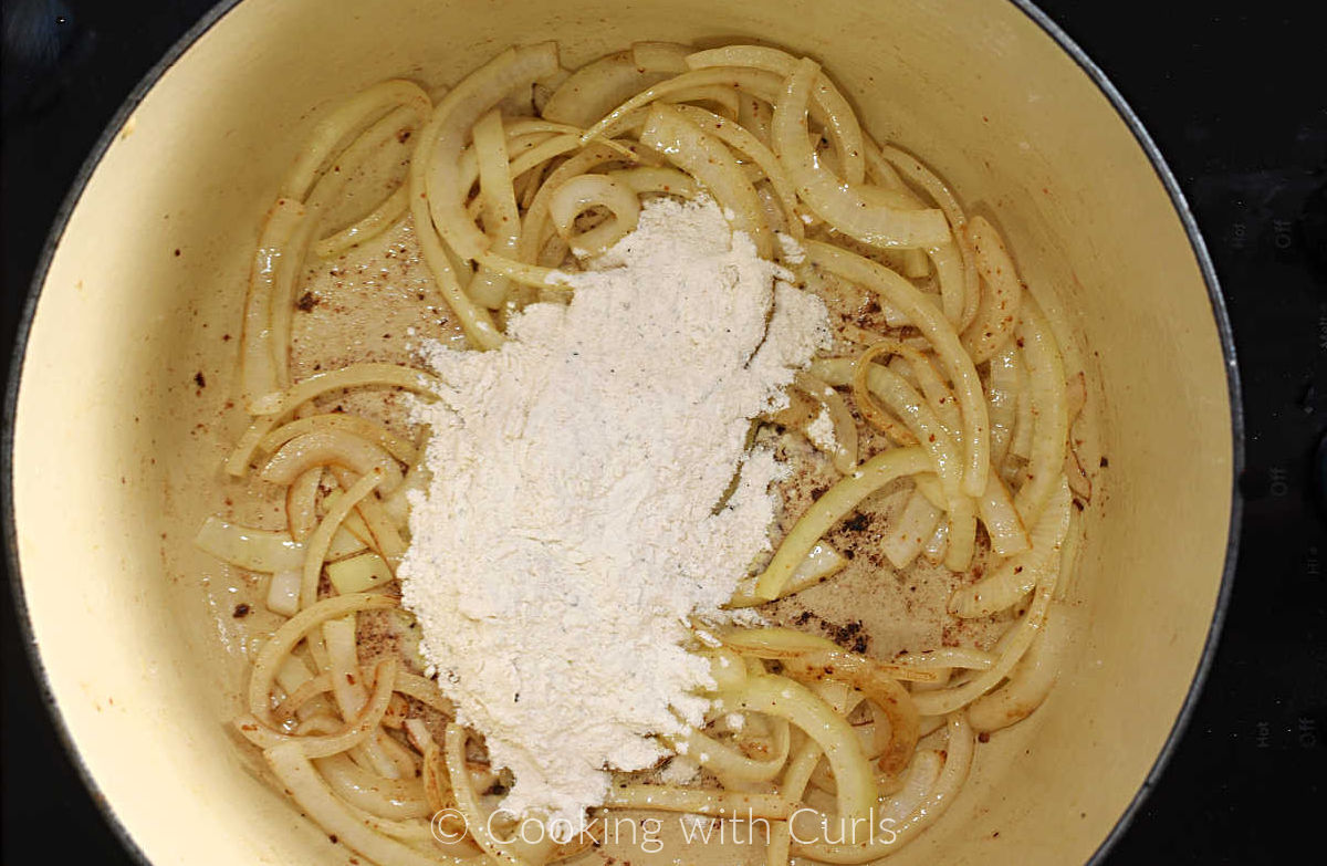 Sliced onions and flour in a Dutch oven. 
