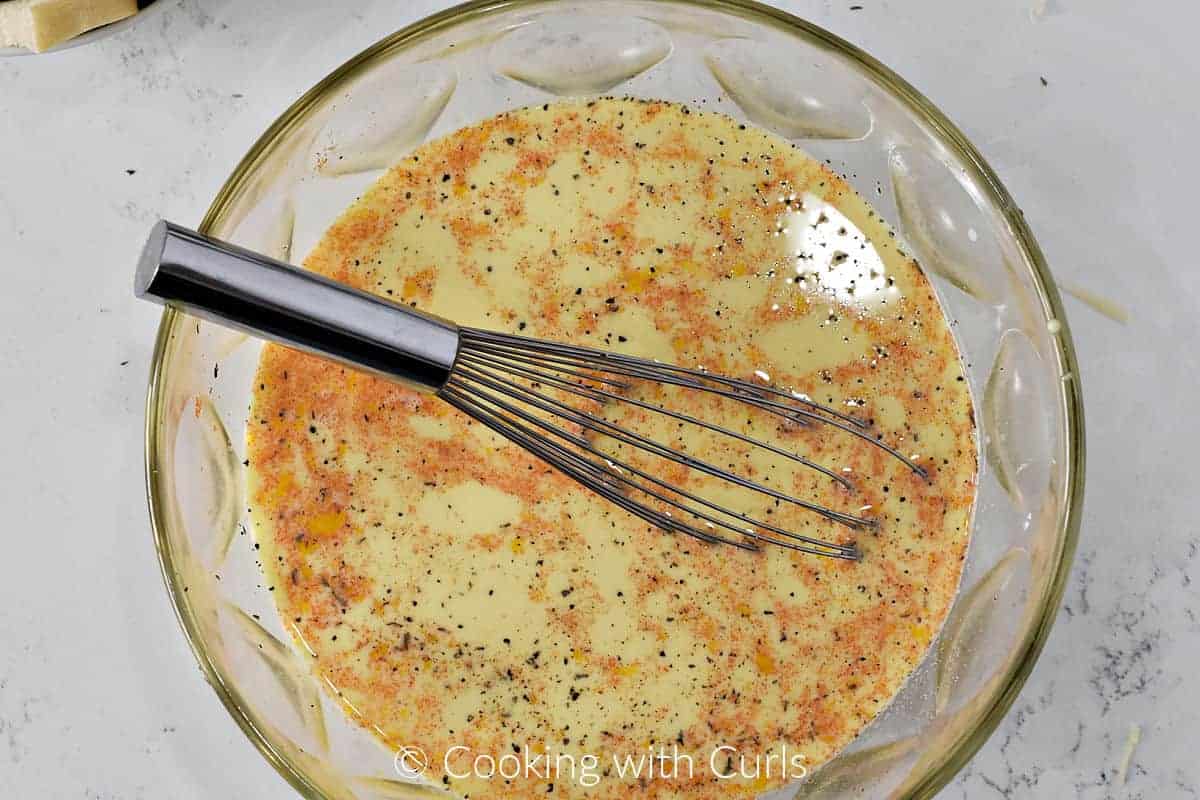 Beaten eggs, milk, and cayenne pepper whisked together in a large bowl. 