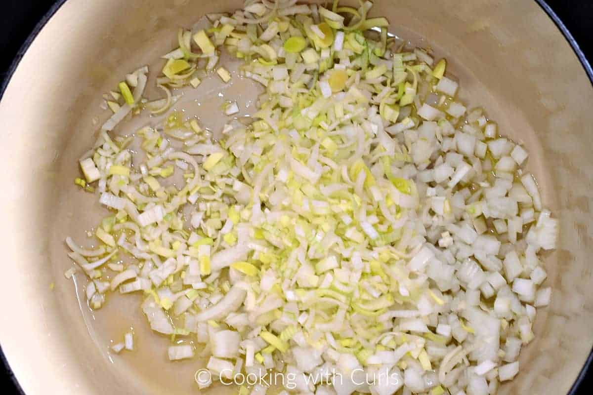 Diced onion and leeks with oil in a Dutch oven. 