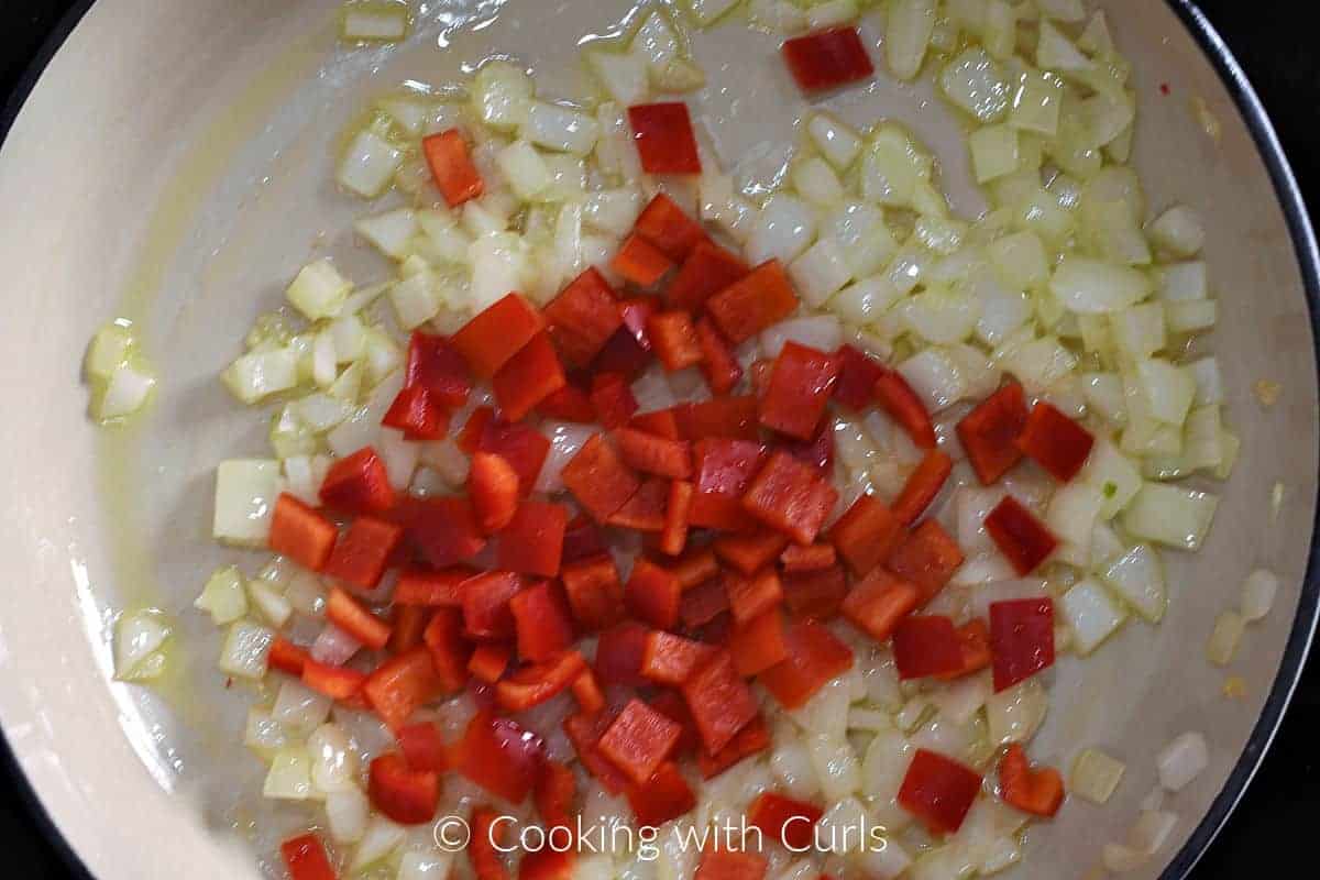 Diced onion and red bell pepper in a skillet with olive oil. 