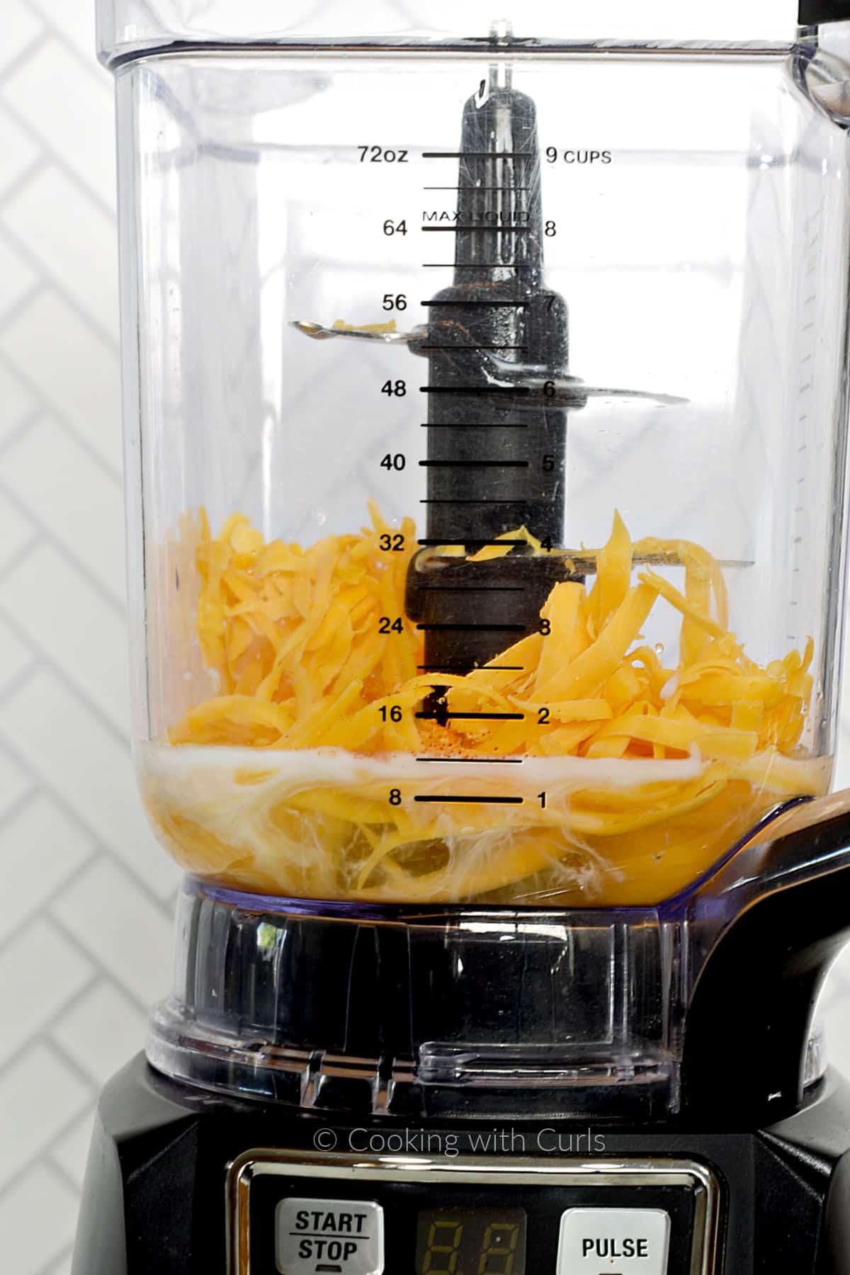 Eggs, grated cheddar cheese and milk in a blender. 
