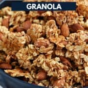 Clusters of Homemade Vanilla Almond Granola in a blue bowl with title graphic across the top.