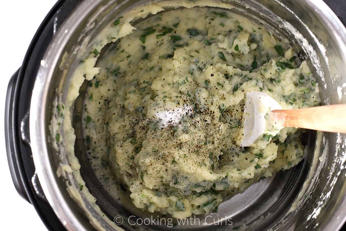 Salt and pepper added to mashed potatoes in pressure cooker. 