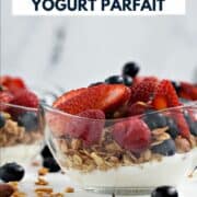 Greek yogurt, granola, fresh raspberries, strawberries and blueberries layered in small glass bowls with title graphic across the top.