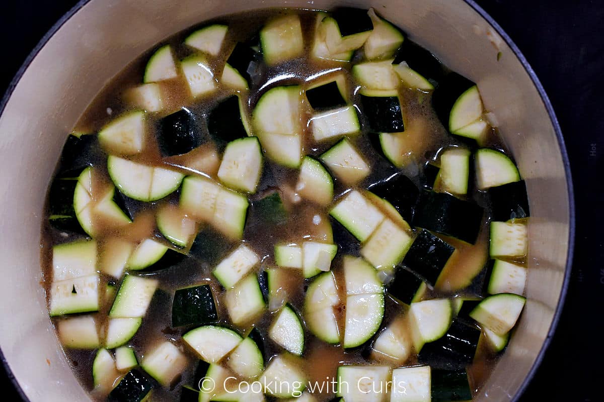 Chopped zucchini and chicken stock in a large pot. 
