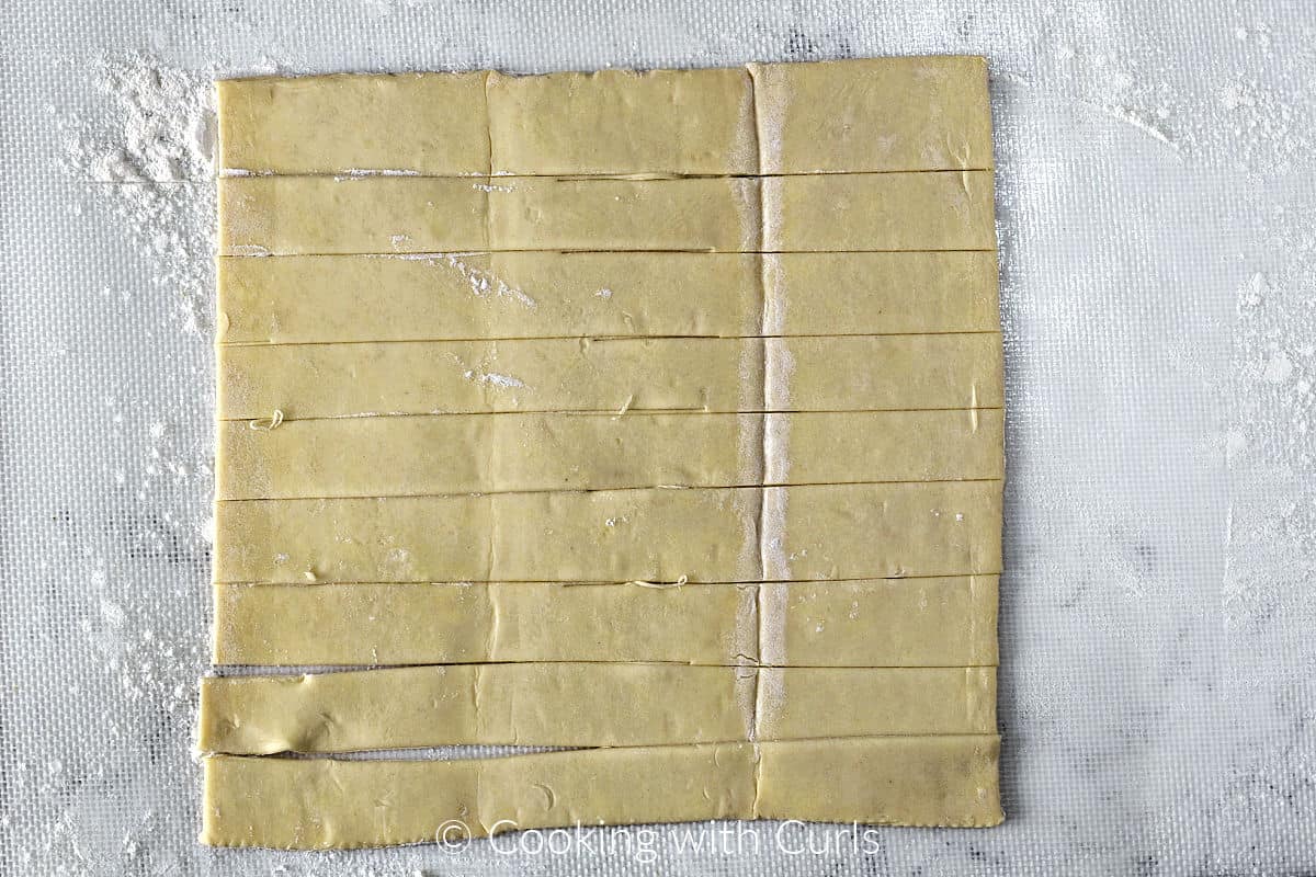 Puff Pastry on a floured surface cut into 8 strips. 