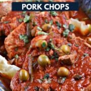 Pork chops on a platter topped with a tomato, olive, caper, and pepper sauce and title graphic across the top.