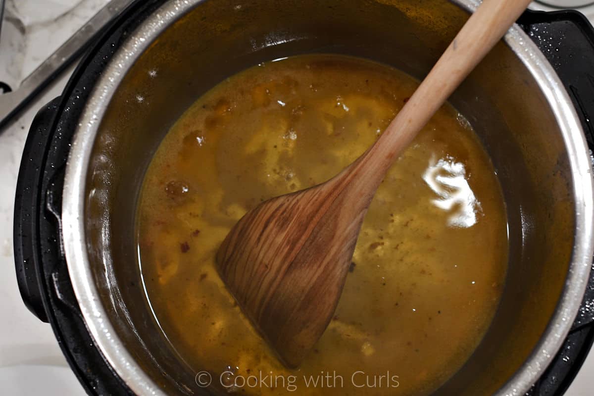 White wine added to the pressure cooker to deglaze the pan with a wooden turner. 