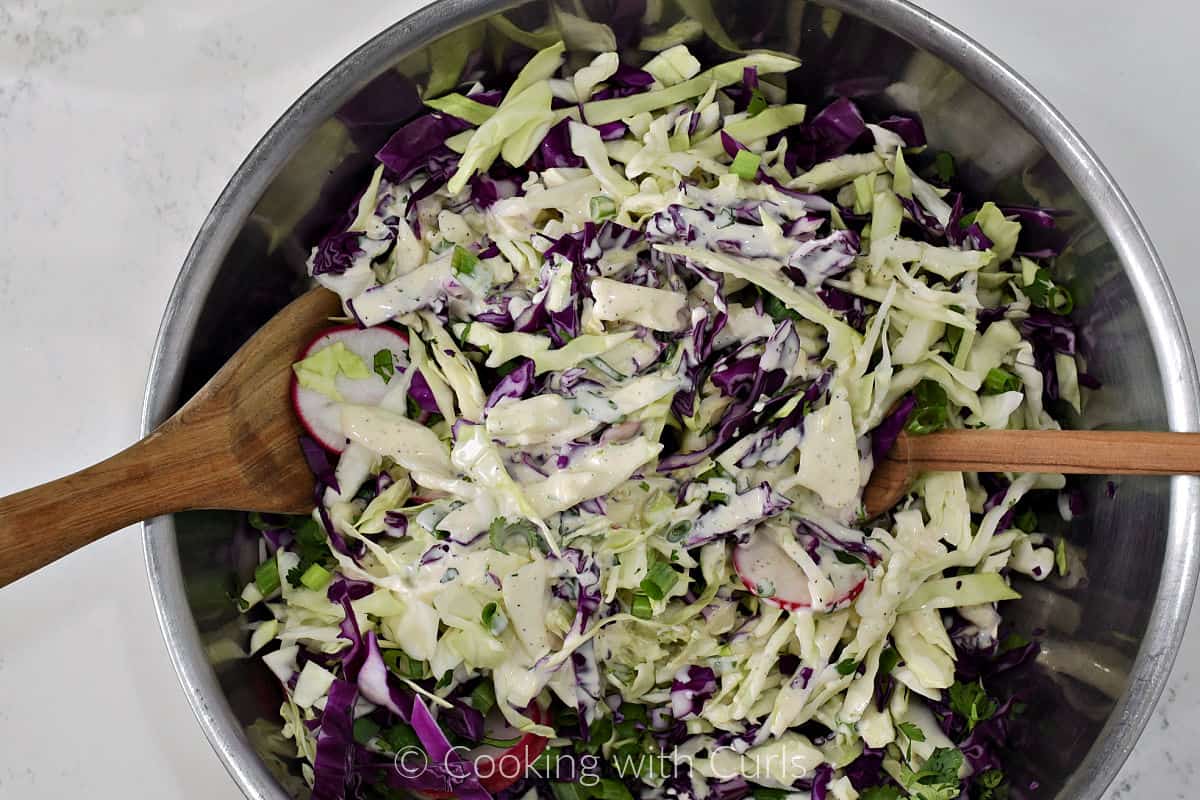 garlic lime sauce added to the cabbage mixture in a large mixing bowl. 
