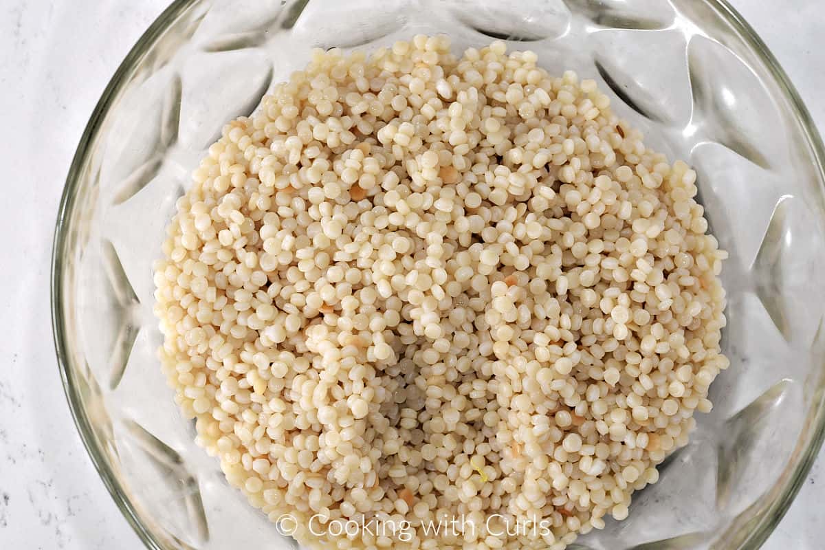 Cooked, drained pearl couscous in a large mixing bowl. 