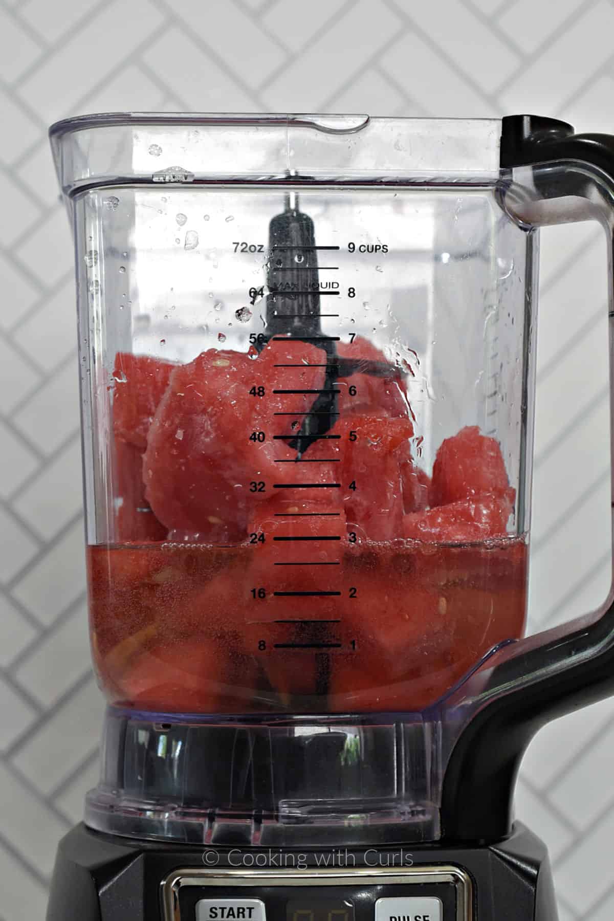 Frozen watermelon chunks and white wine in a blender. 