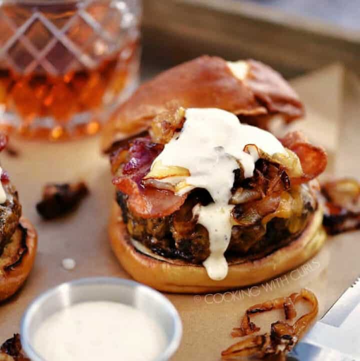 A cheeseburger topped with bacon and whiskey aioli.