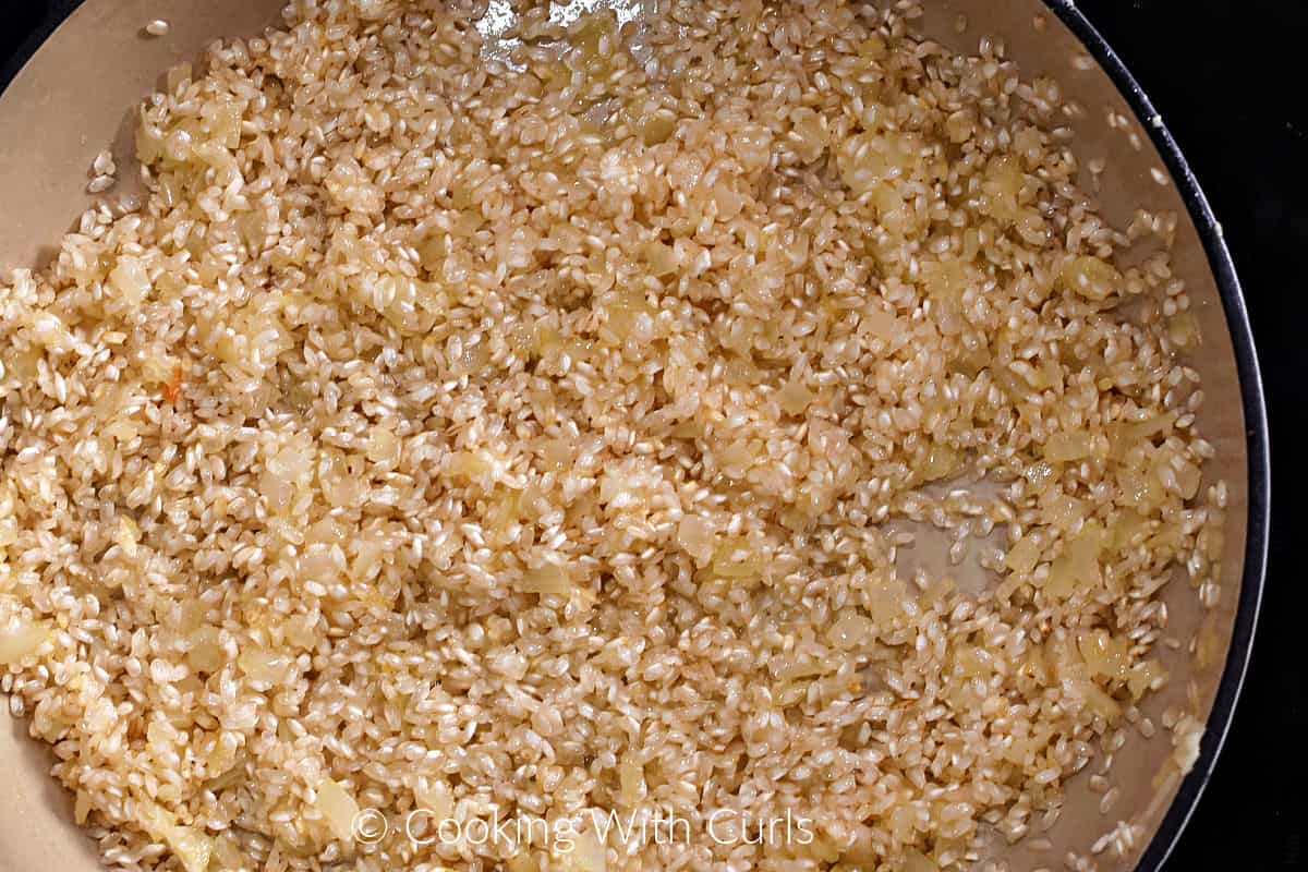 Arborio rice, oil, and diced onion in a skillet. 