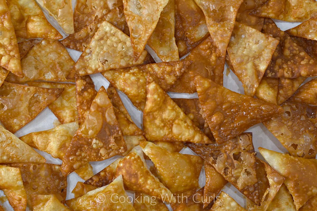 Fried Wonton Chips on a parchment lined baking sheet. 