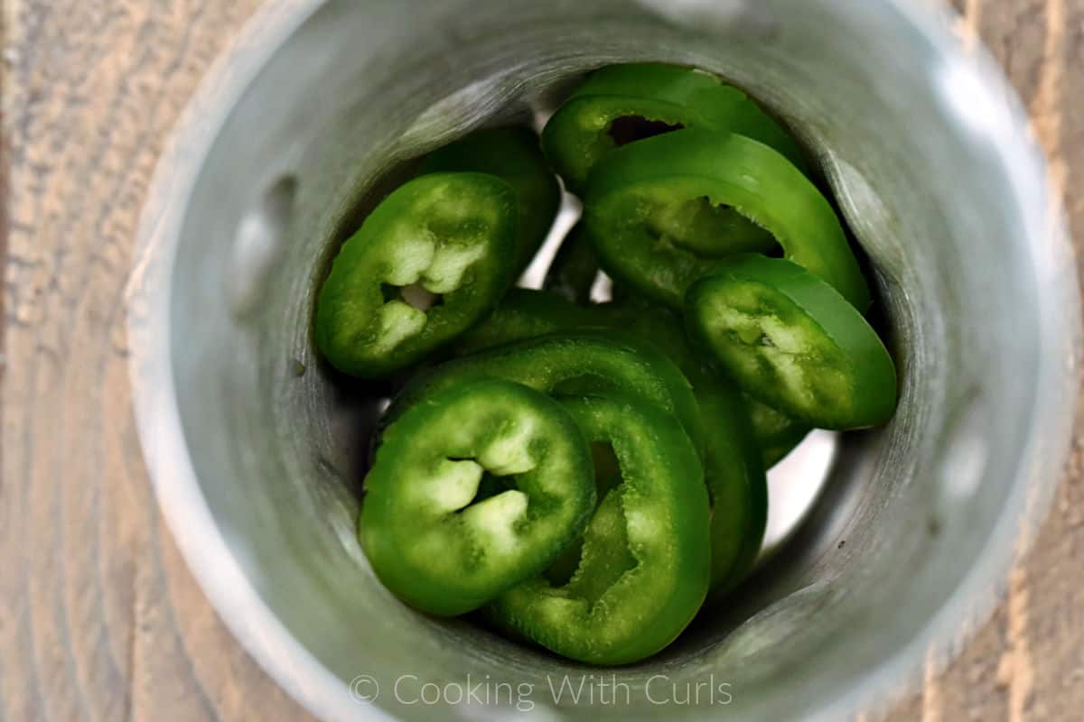 Jalapeno slices in a cocktail shaker. 