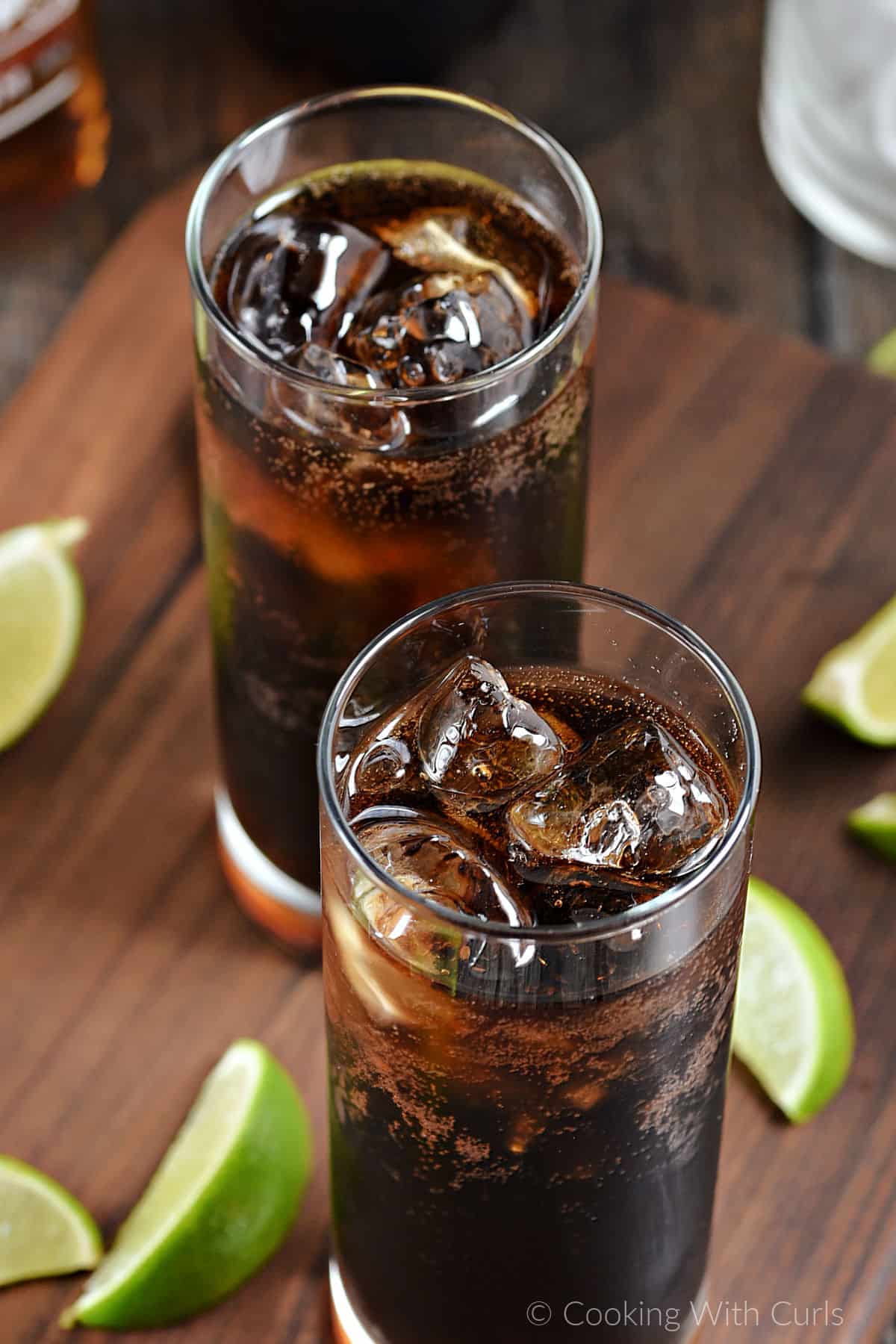 Two glasses filled with ice, rum and cola. 